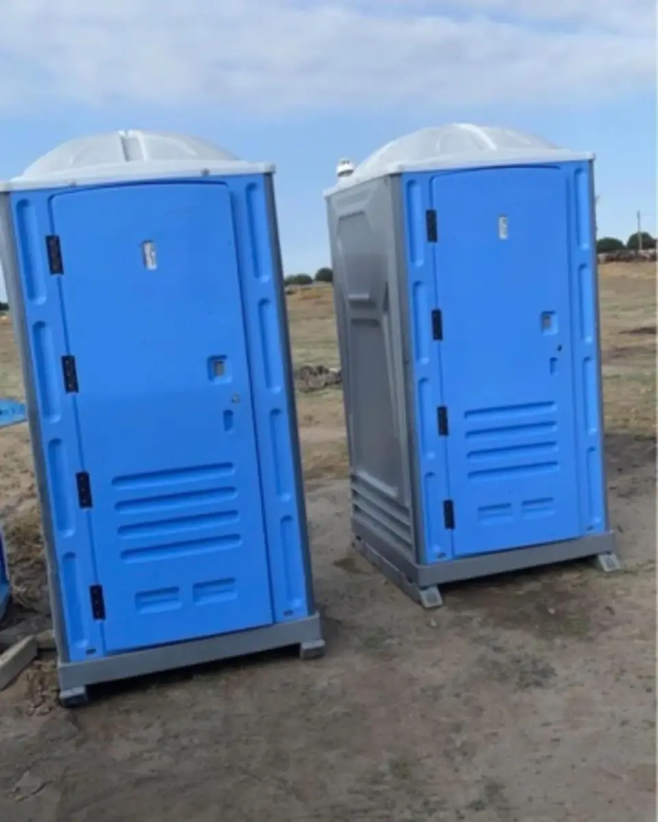 Standard portable toilets beside a work area